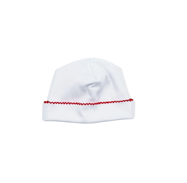 White baby hat with red trim on a white background